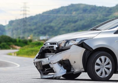 Front of silver car get damaged by crash accident on the road. Car repair or car insurance concept